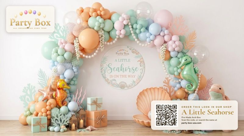 A Little Seahorse baby shower balloon arch: seafoam, peach, lilac and pastel blue balloons with seahorse balloons, seashells and coral