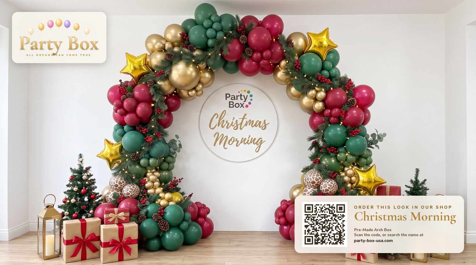 Christmas Morning balloon arch: crimson, evergreen and gold chrome balloons with pine garland, berries and gold stars over wrapped presents and a mini tree