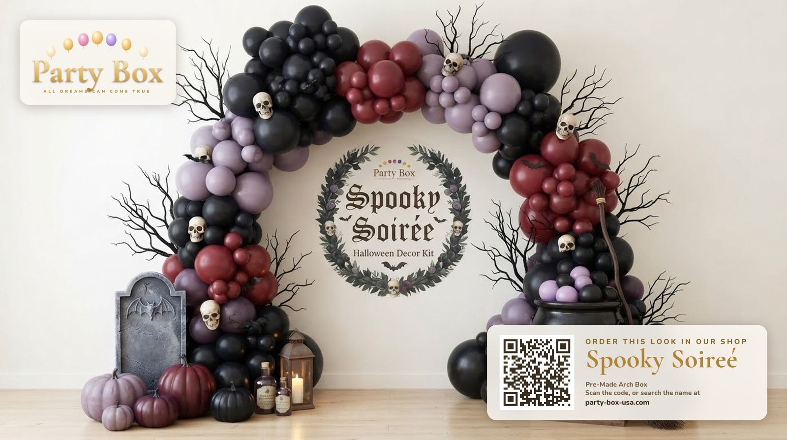 Spooky Soirée Halloween balloon arch: black, maroon and dusty indigo balloons with bare branches, skulls, a tombstone and a witch cauldron